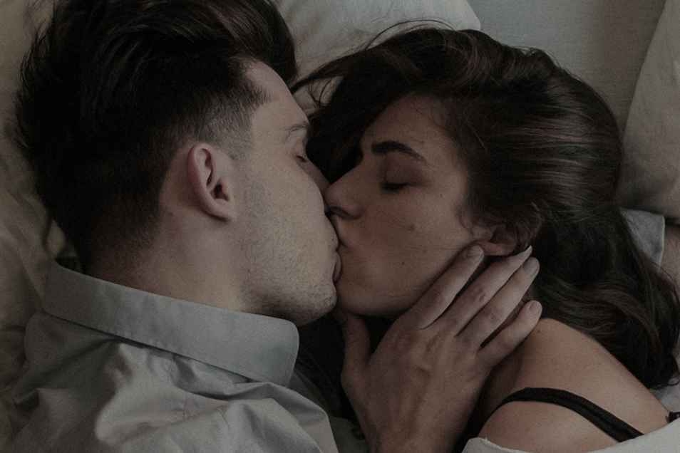 Couple kissing in bed