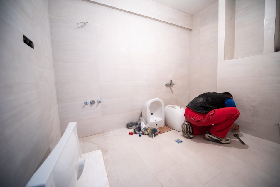 a remodeling contractor renovating bathroom tiles