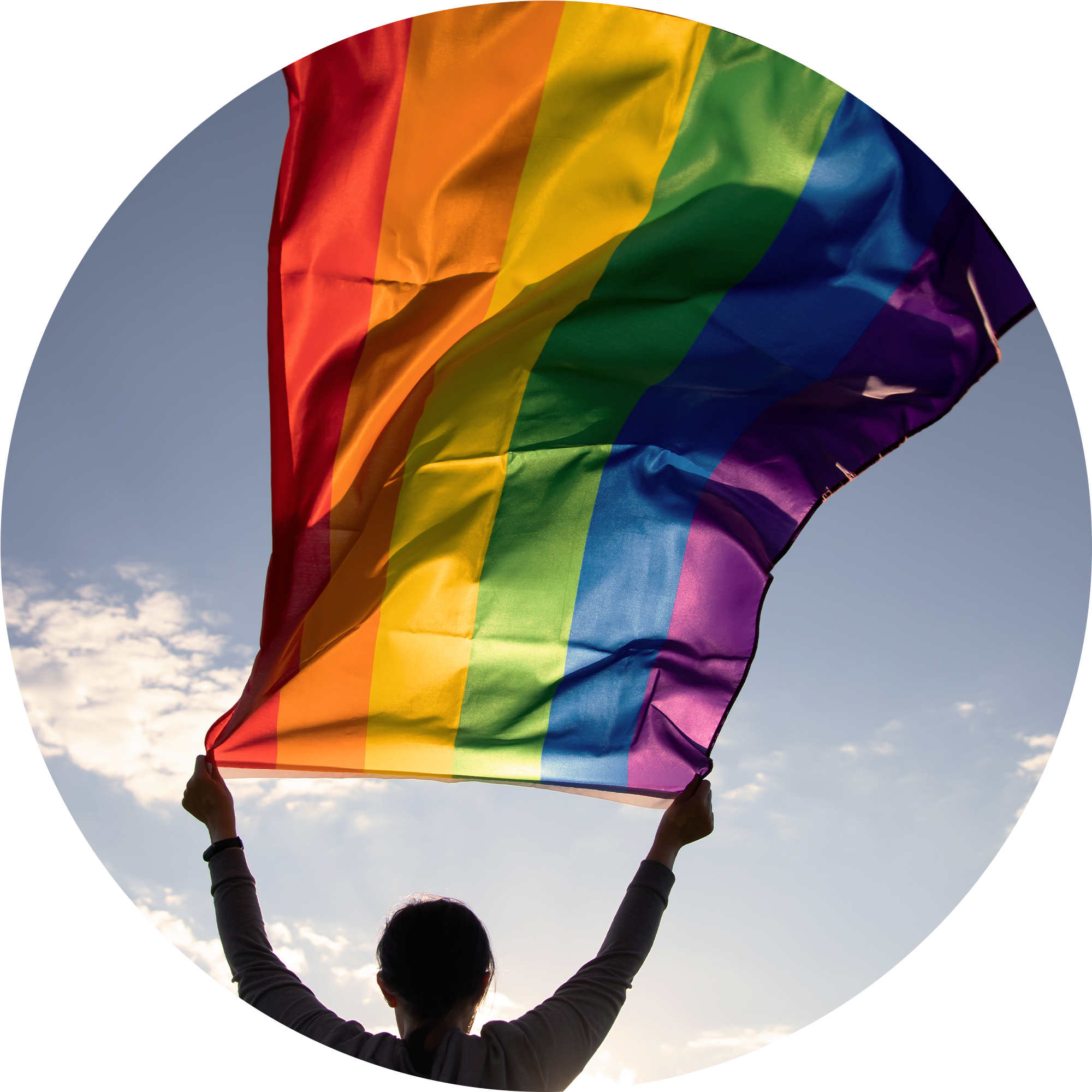 Person waving Pride flag from window