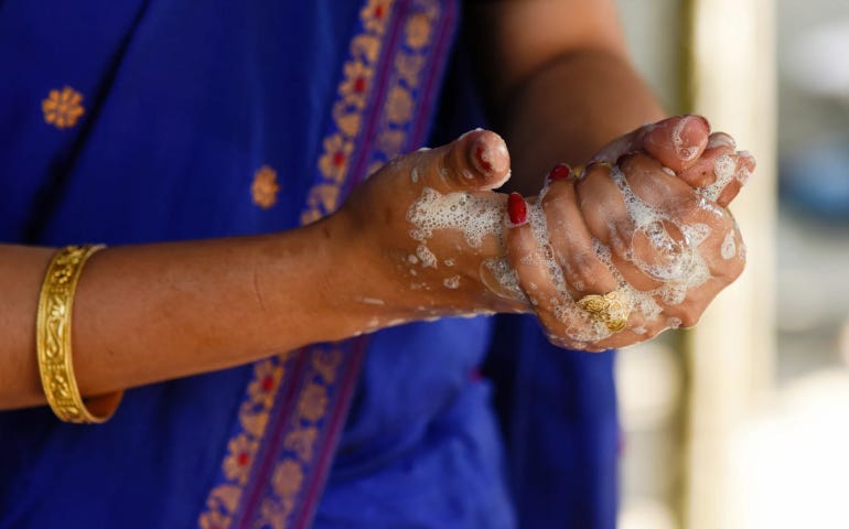 a woman washing her hands