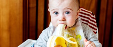 Baby eating banana