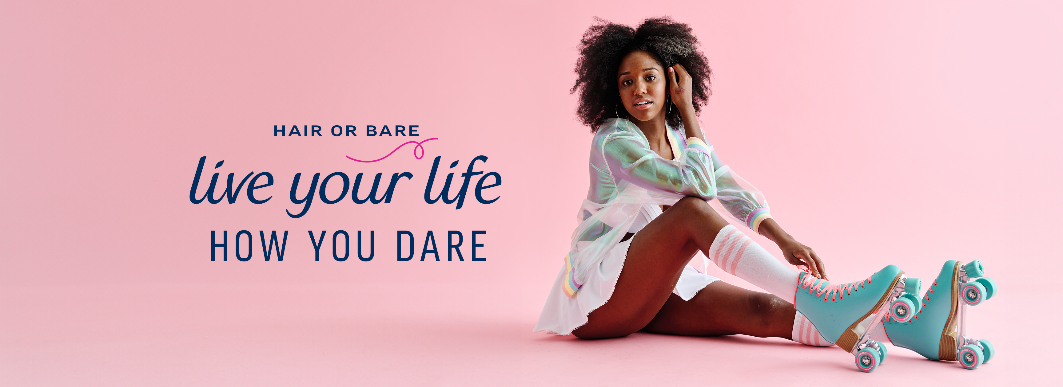 Young woman with curly hair sits on a pink floor, wearing turquoise roller skates and a white outfit, next to the text "Live your life how you dare."
