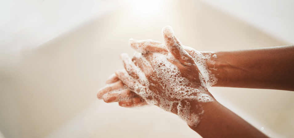a person is washing hands with soap
