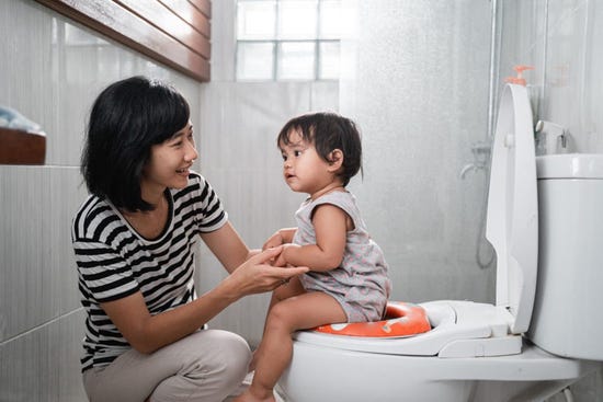 Mother and baby on the toilet