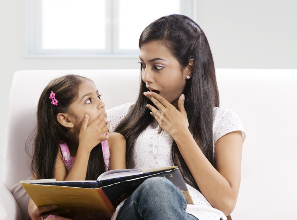 Woman with a girl are reading