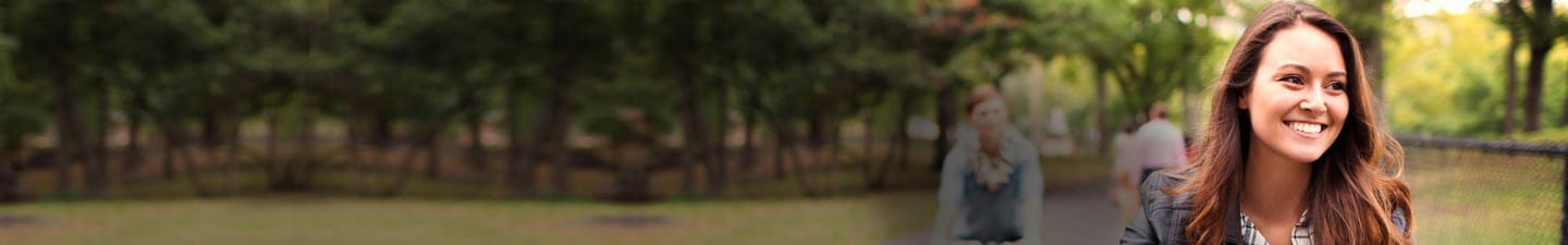 Smiling woman outdoors with Scalpicin product displayed on the left