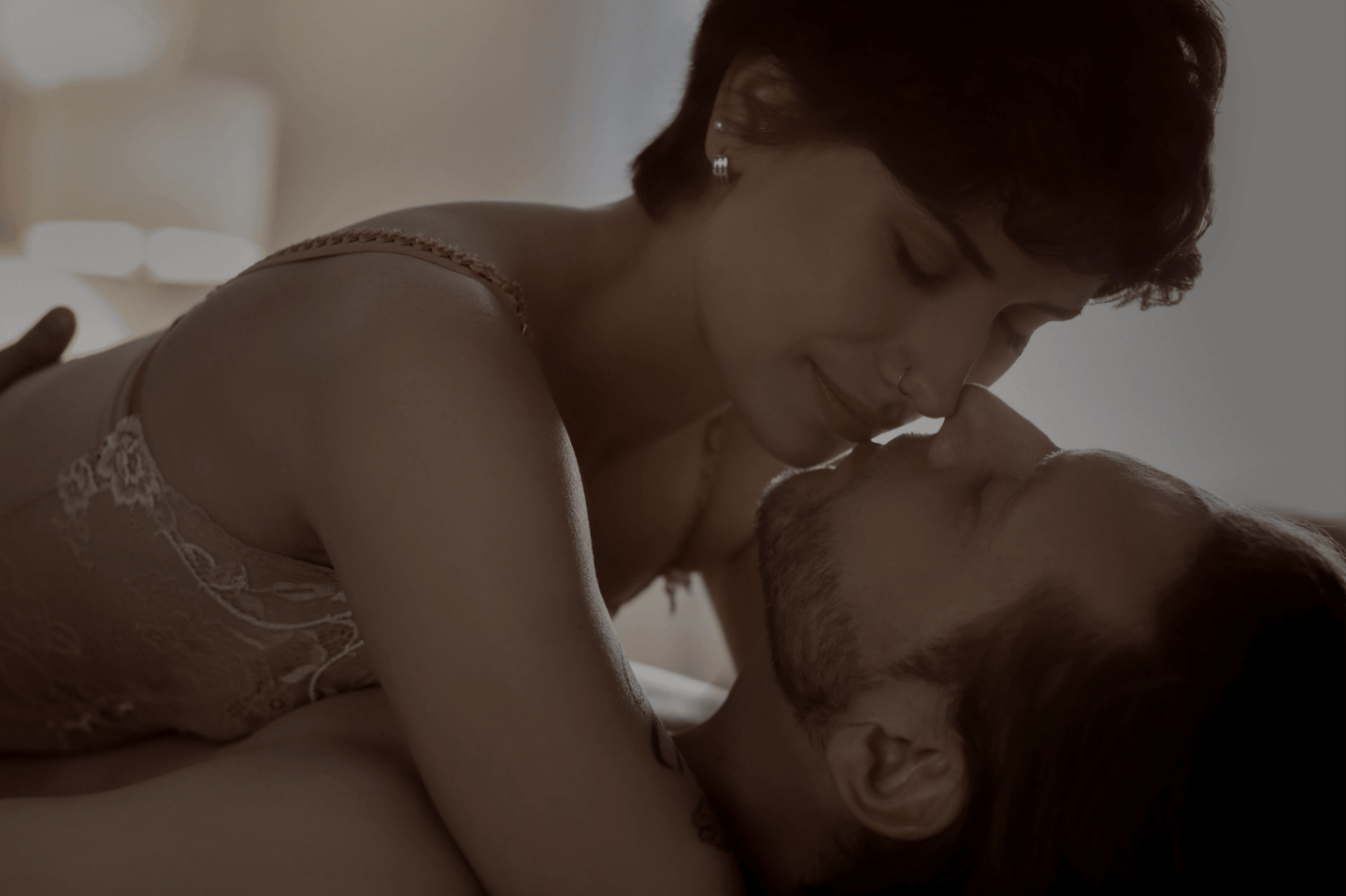 Un couple en tenue intime s’embrasse pour rétablir l’intimité avant de dormir.