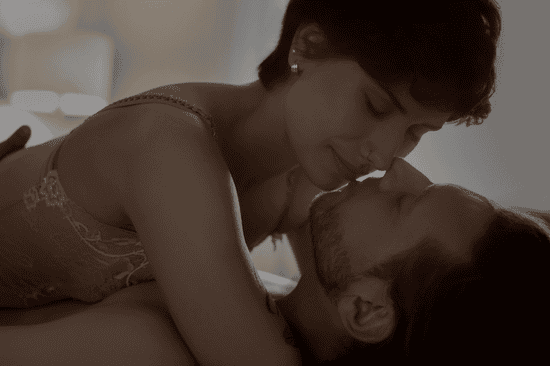 Couple in their intimate wear, kissing to rebuild intimacy before bed