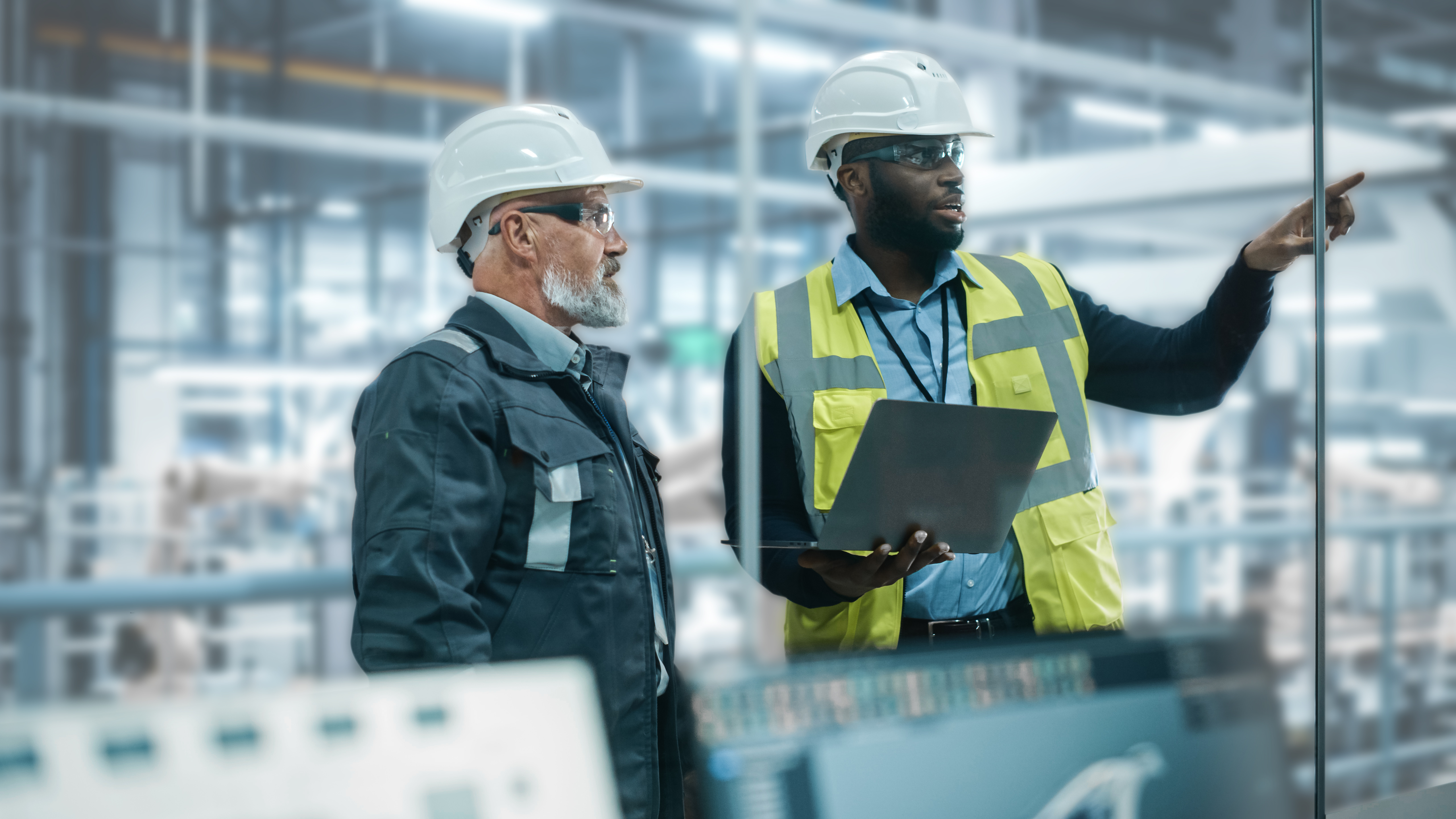Two men talking in a factory - Stock photo