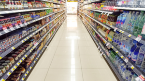 A grocery aisle with blurred out product on shelves. A grocery aisle with blurred out product on shelves.