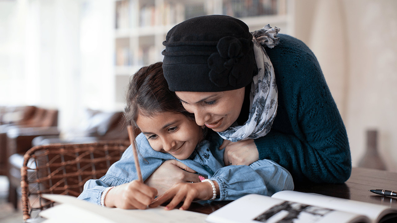 mother-embracing-daughter-studying-at-home mother embracing daughter studying at home