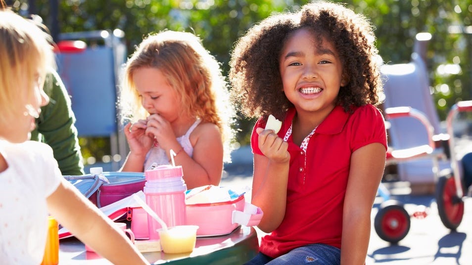 a child eating lunch in a lunch break at school
