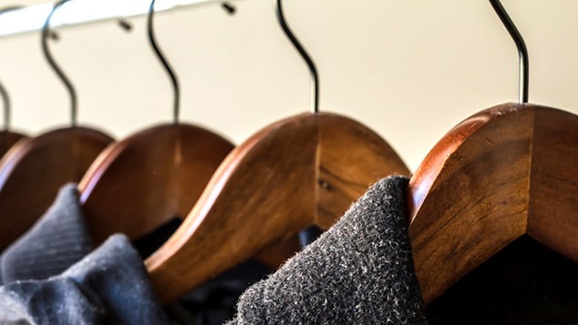 Clothes hanging on wooden hangers