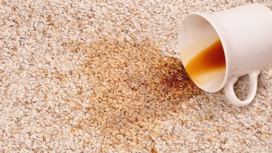 Coffee being spilled onto a carpet
