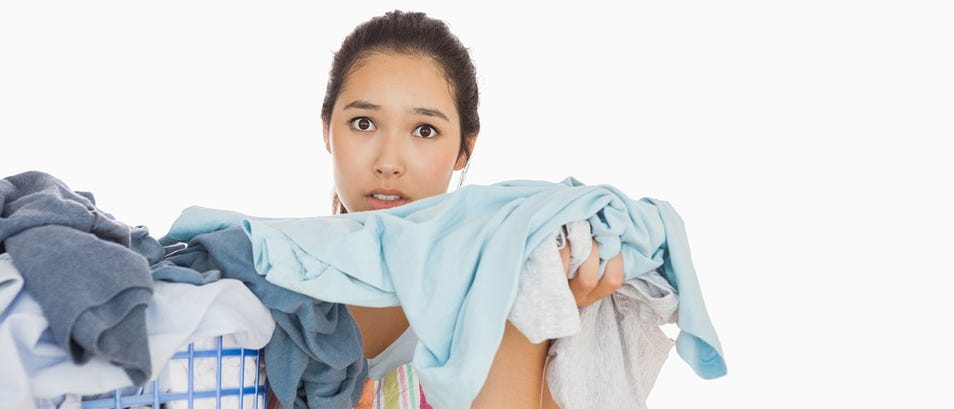 women holding the laundry clothes with a surprise look