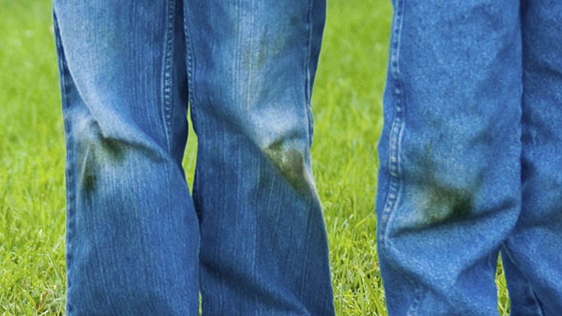 pairs of blue jeans with grass stains on the knees