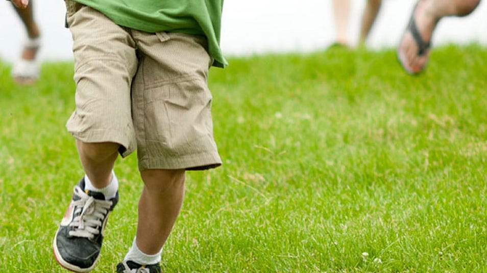 someone running on the grass while wearing sneaker shoes