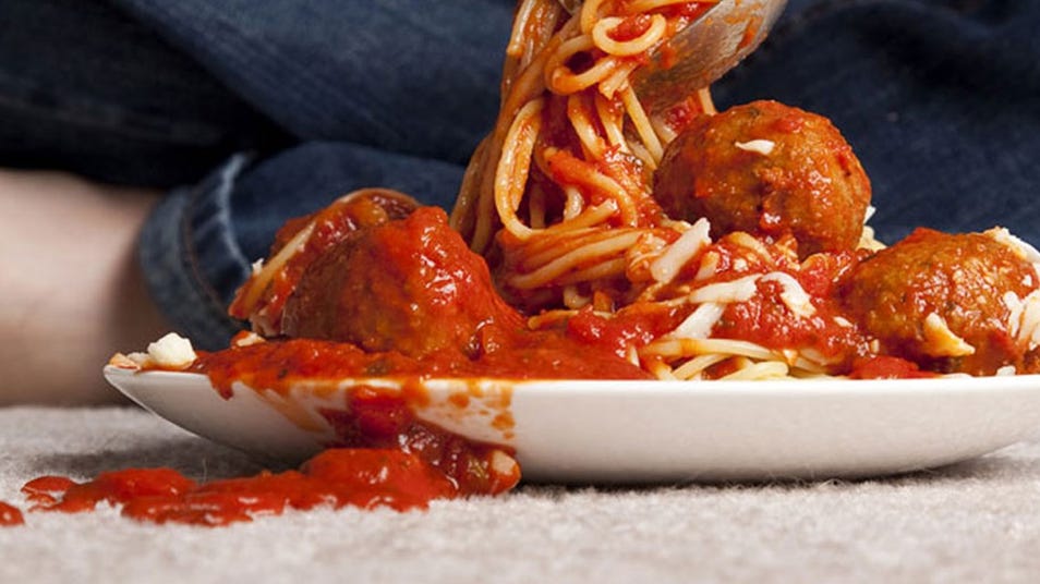 Spaghetti and meatballs with spilled sauce