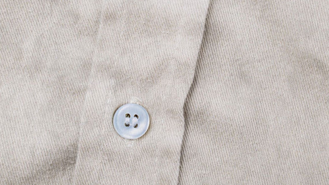 Close-up of a beige shirt button