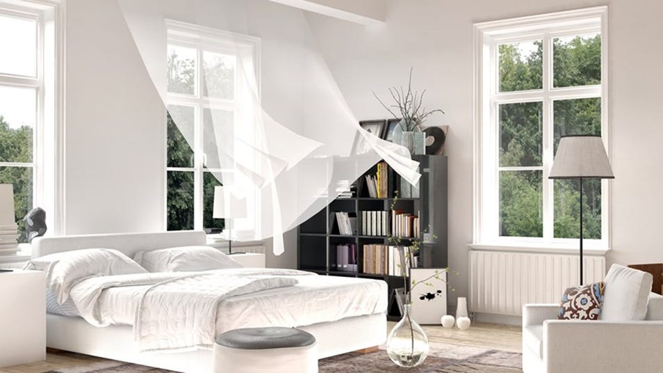 Bright bedroom with white bed and sheer curtains