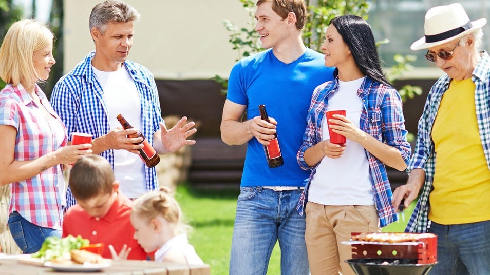 people having drinks and laugh at a bar b cue party