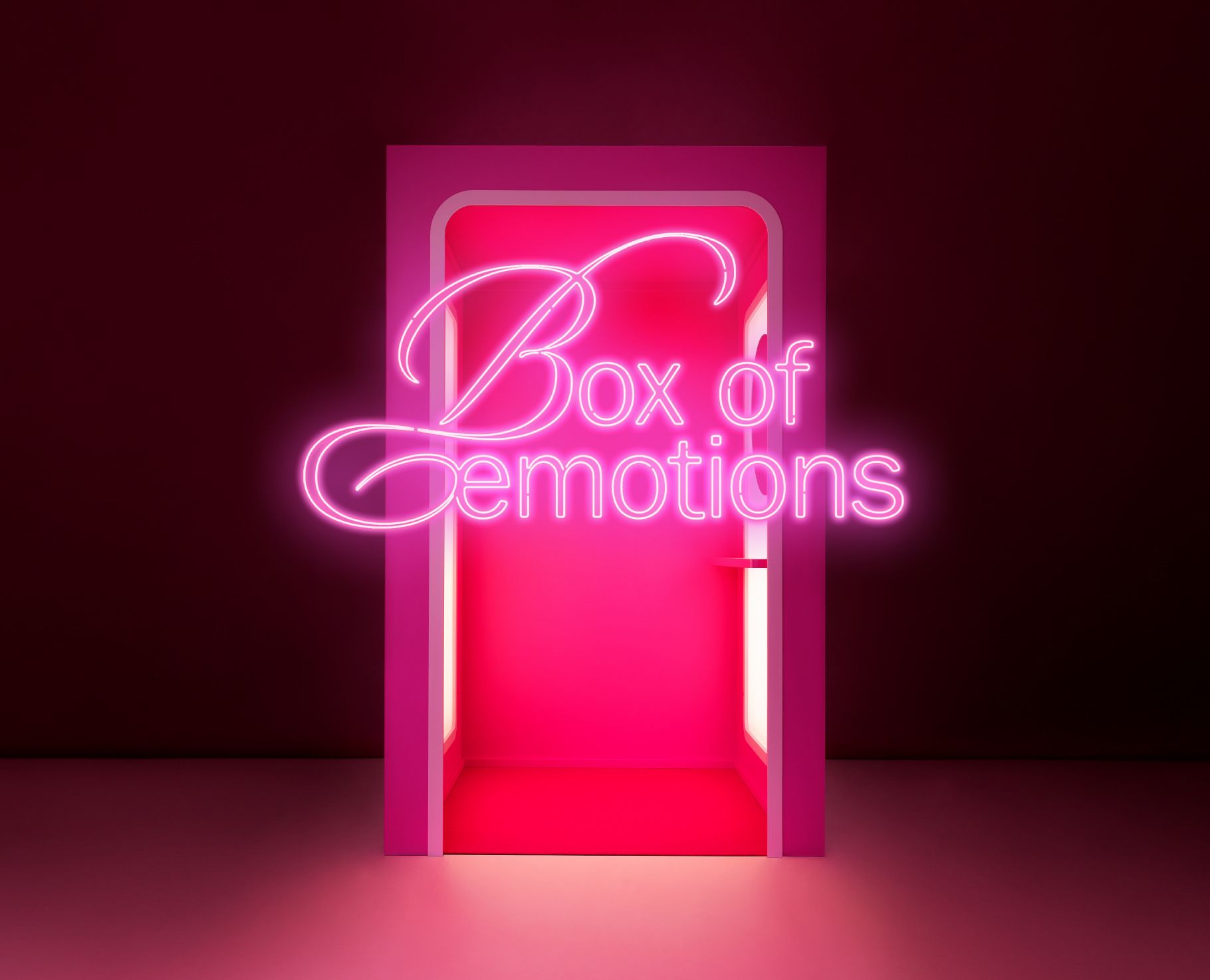 The pink and red Sokos Box of Emotions fitting room for trying on beauty products glows against a dark background. The pink and red Sokos Box of Emotions fitting room for trying on beauty products glows against a dark background.