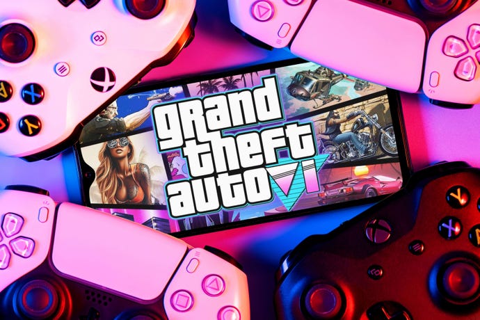 Mockup of a mobile phone with a Grand Theft Auto VI screen logo, surrounded by pink game controllers