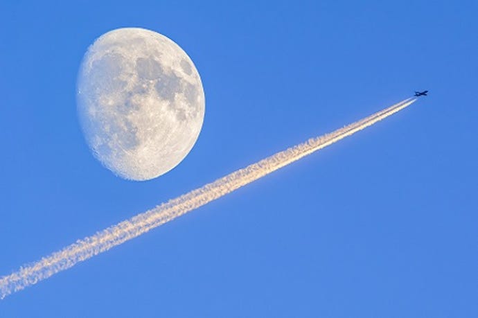The moon with a rocket whizzing past in the sky