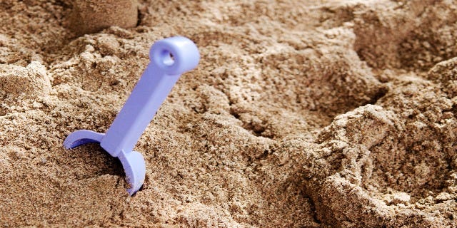 beach sand with a sand shovel in it