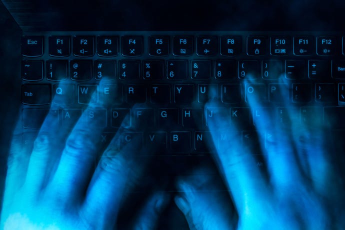 blue hacker hands over keyboard