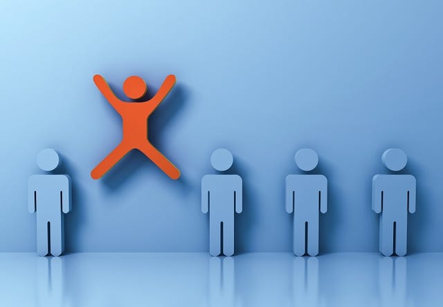 cutout of blue people in a line, with a red one jumping for joy