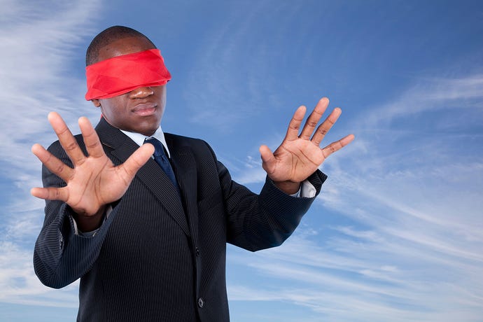 businessman with a red blindfold covering his eyes