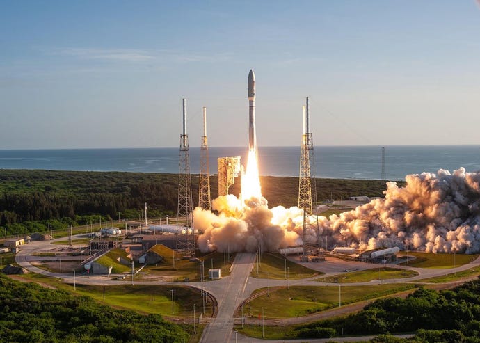 With blue sky as a backdrop, a United Launch Alliance Atlas V 541 rocket lifts off from Space Launch Complex 4