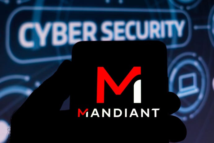 Mandiant logo on a smartphone in the forefront of a backdrop representing cybersecurity.
