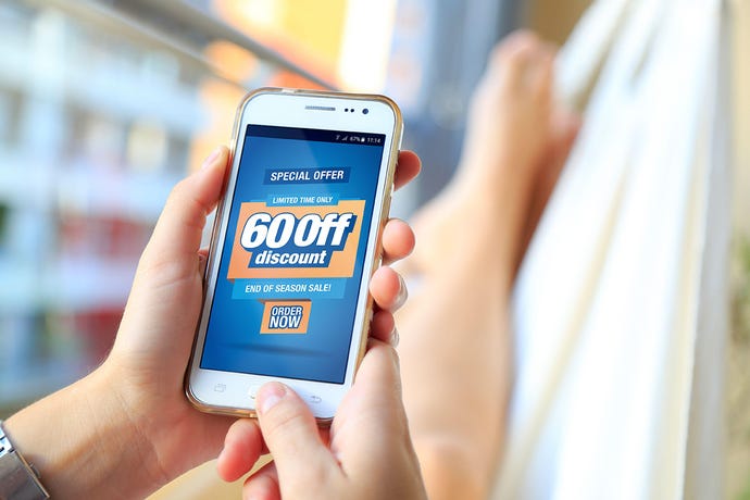 Woman in a hammock with a smartphone with a 60% discount advertising on the screen.