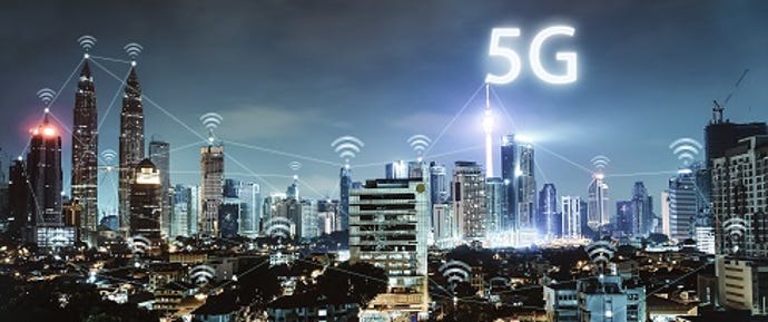 Photo illustration of a glowing city at night, with the term 5G floating in the air