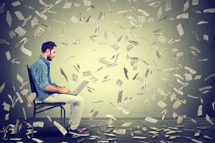 Man on laptop while it rains money