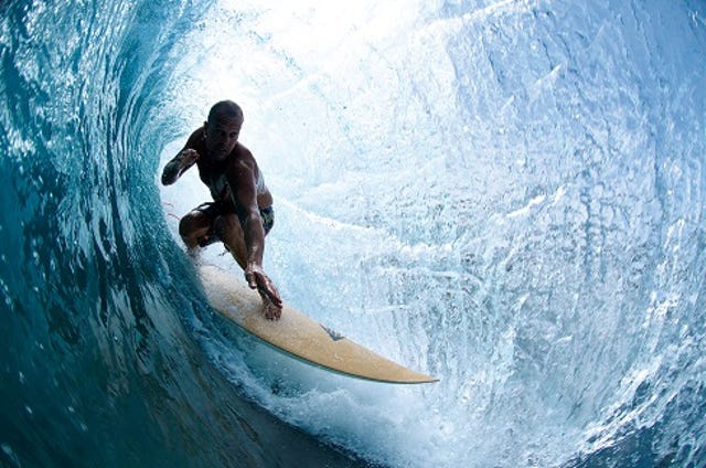 surfer in a big wave tube