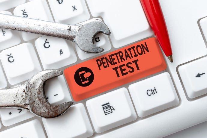 The words "Penetration test" on a keyboard, with wrenches