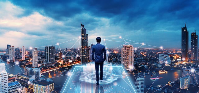 A man stands looking off into a futuristic-looking city
