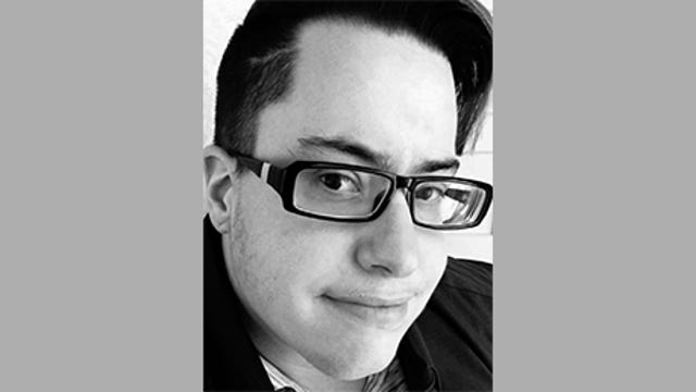 Rin Oliver, a software engineer at US Bank, has short dark hair and glasses