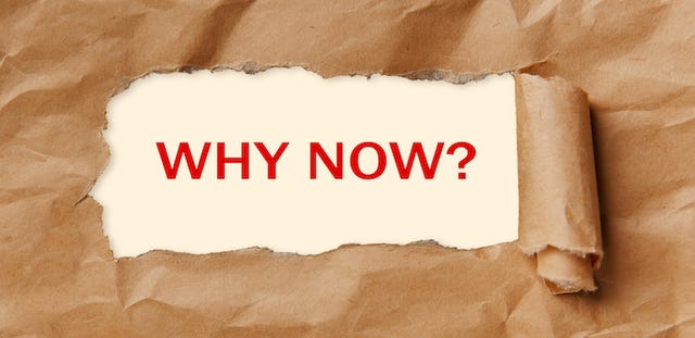 piece of paper peeled away to show the question "Why now?" in red.