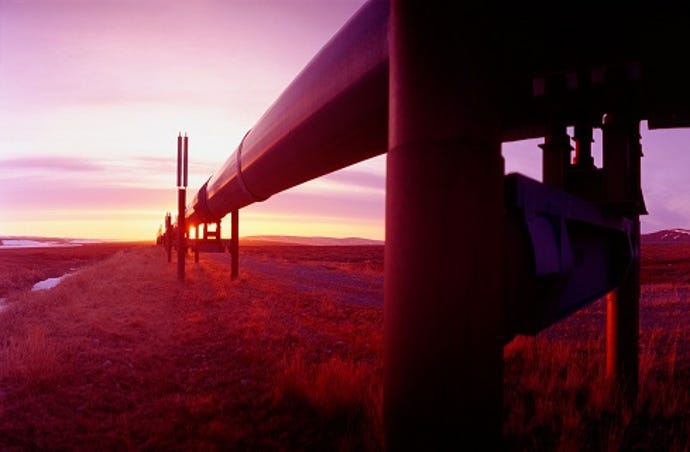 An image of a pipeline with a sunset in the background.