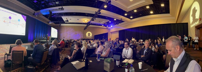 Executives and security professionals sit in a conference room at Black Hat USA listening with rapt attention to Omdia analysts