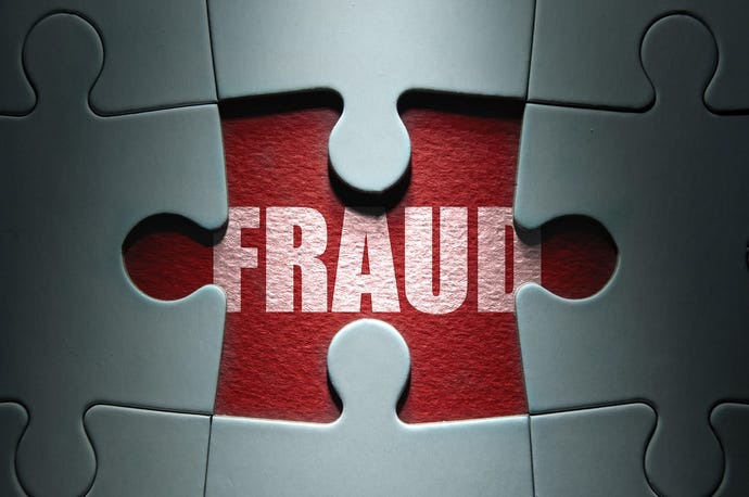 The word "FRAUD" between puzzle pieces