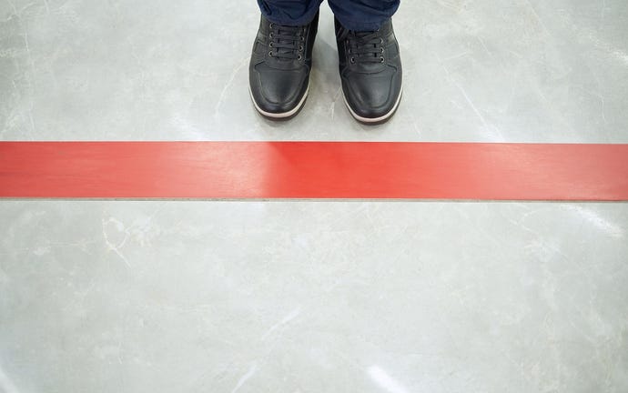 Person standing by a red line