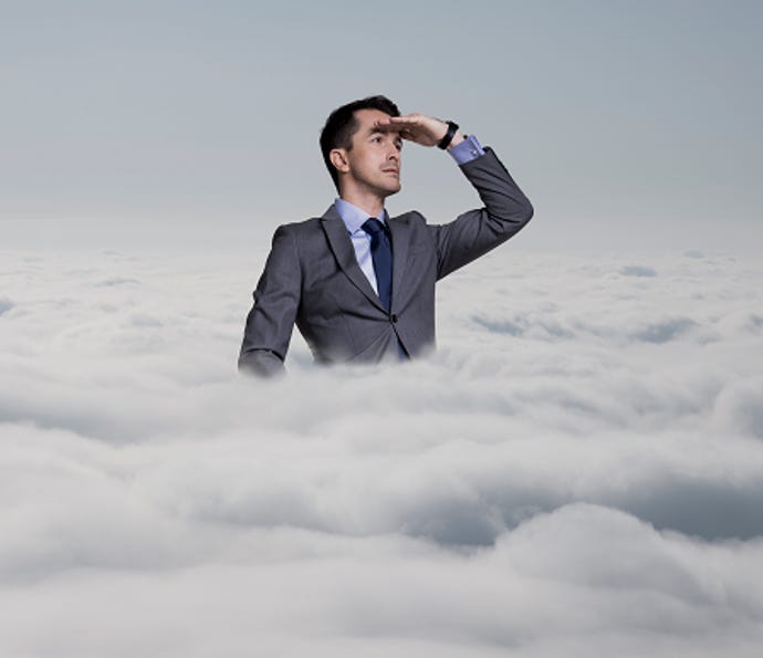 Man in suit looking in the distance while standing inside a cloud.