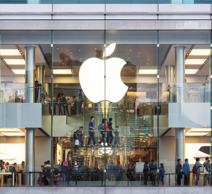 The front of an Apple Store with the Apple logo at the center