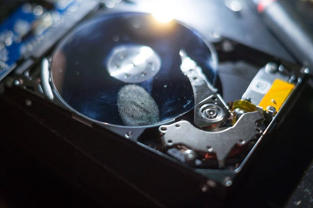 Photo of a hard drive disc with a visible fingerprint on it