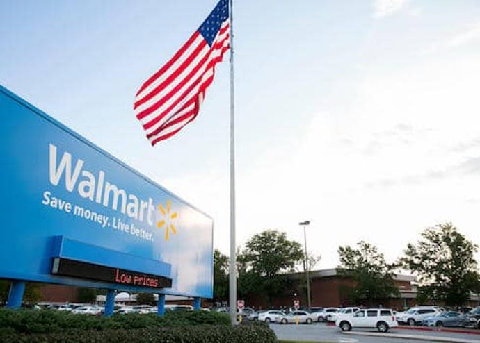 Walmart headquarters with American Flag and parking lot